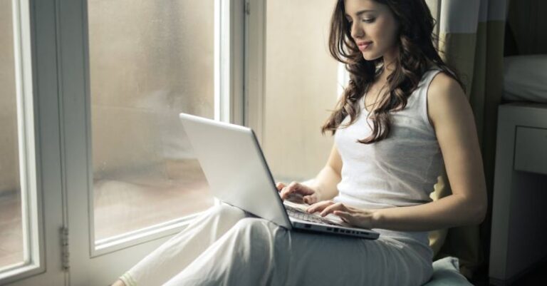 Computer - Woman Wearing Tank Top Sitting by the Window
